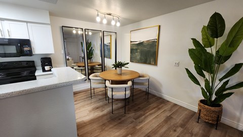 A kitchen with a table and chairs in the middle of the room.