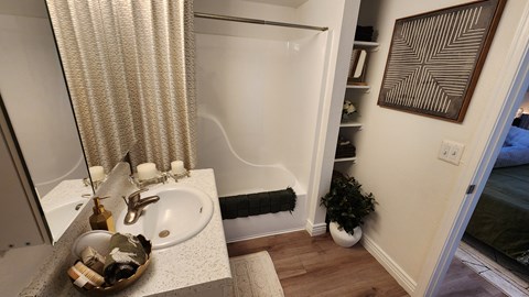 A bathroom with a white sink and a shower curtain.