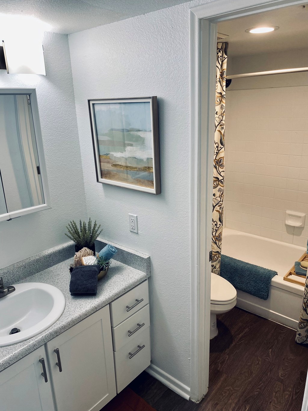 A bathroom with a white sink and a white toilet.