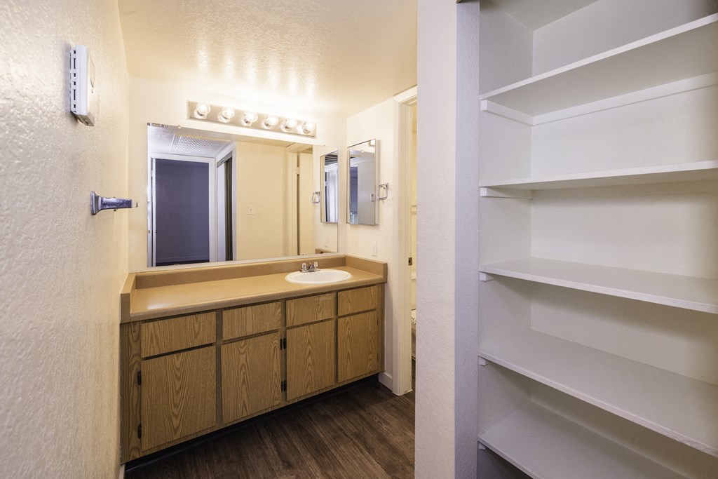A bathroom with a sink and mirror.