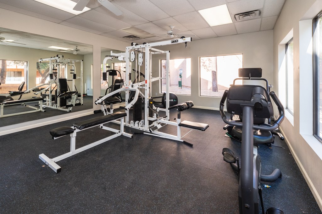 A gym with a variety of equipment including a leg press machine.