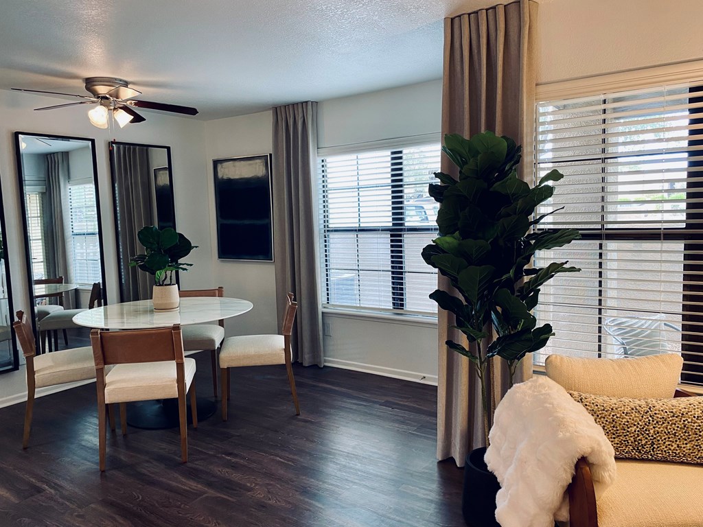 A living room with a dining table and chairs.