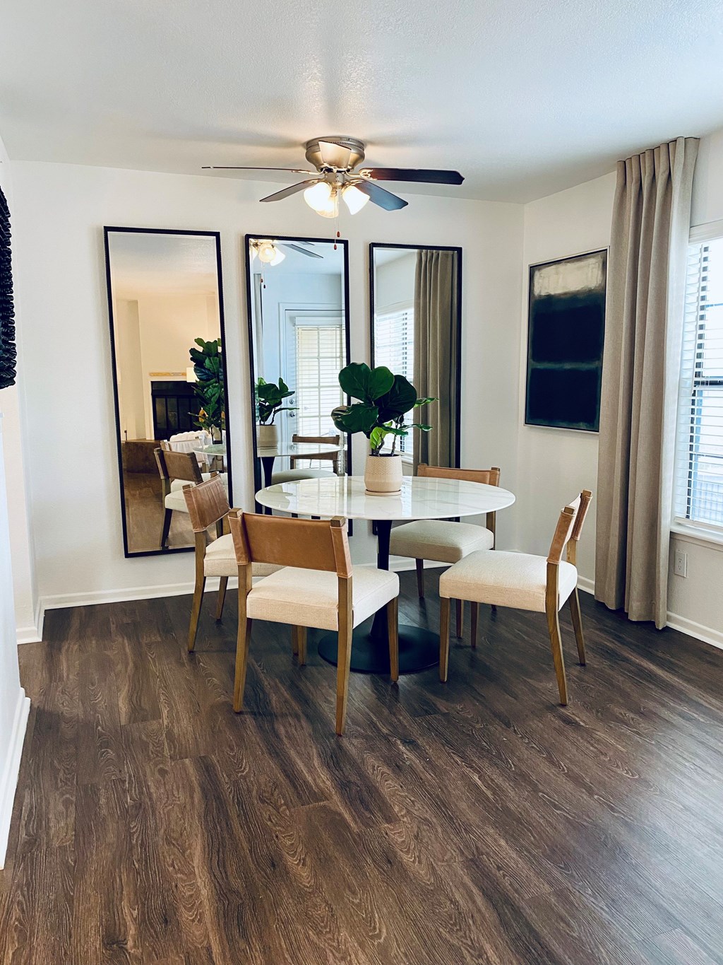 A dining room with a round table and chairs.