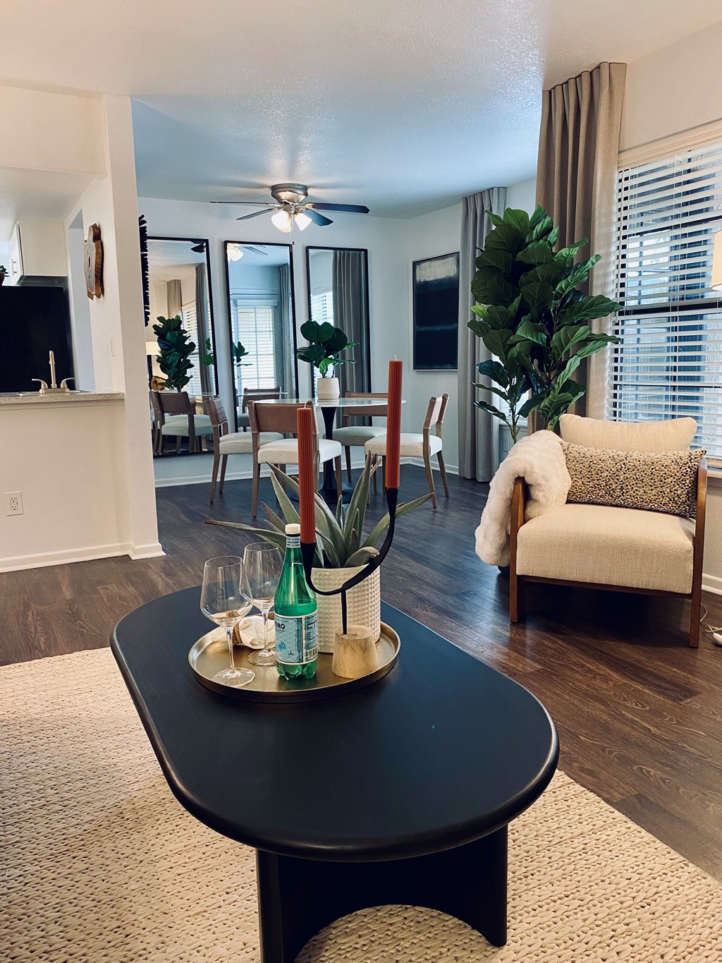 A black coffee table with a tray on it in the middle of a room.