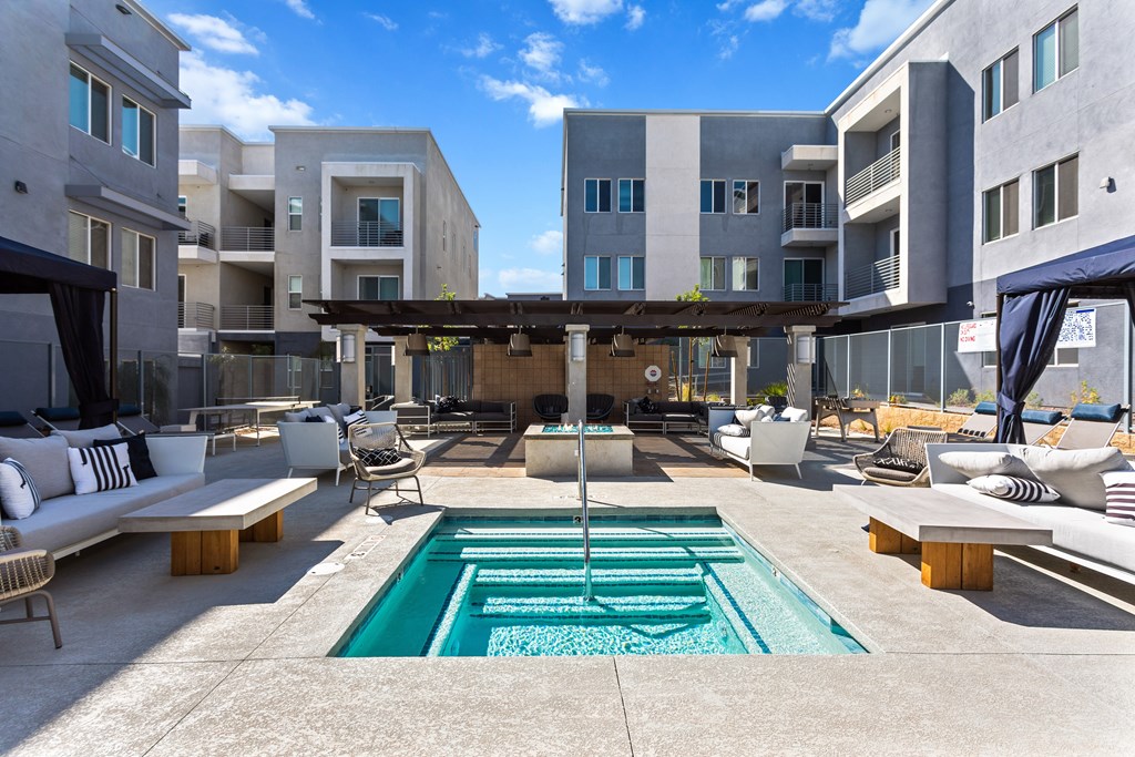 A modern outdoor living space with a pool and lounging area.