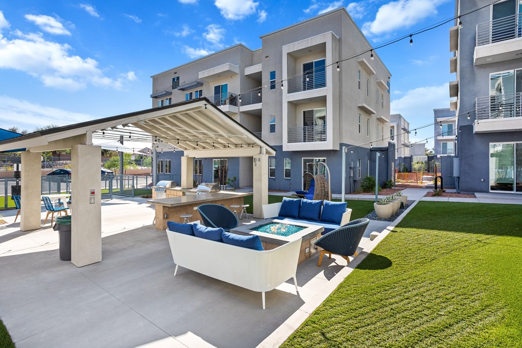 A modern outdoor seating area with a table and chairs is set up in front of a building.