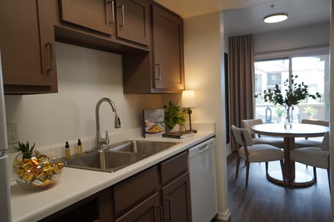 A kitchen with brown cabinets and a white countertop.