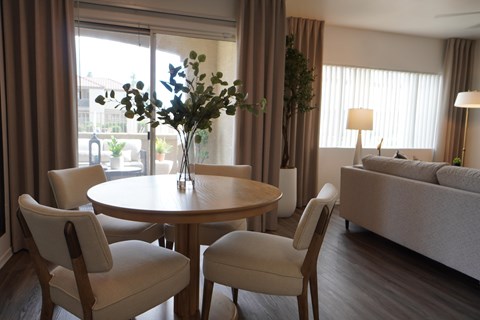 A living room with a round table and chairs.