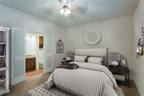 a bedroom with a bed and a ceiling fan