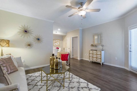 a living room with furniture and a ceiling fan