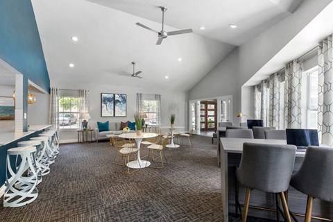 a living room with tables and chairs and a dining room