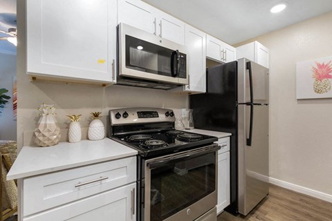 a kitchen with a stove microwave and refrigerator