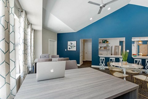 a living room with a laptop on a wooden table