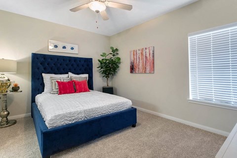 a bedroom with a bed and a ceiling fan