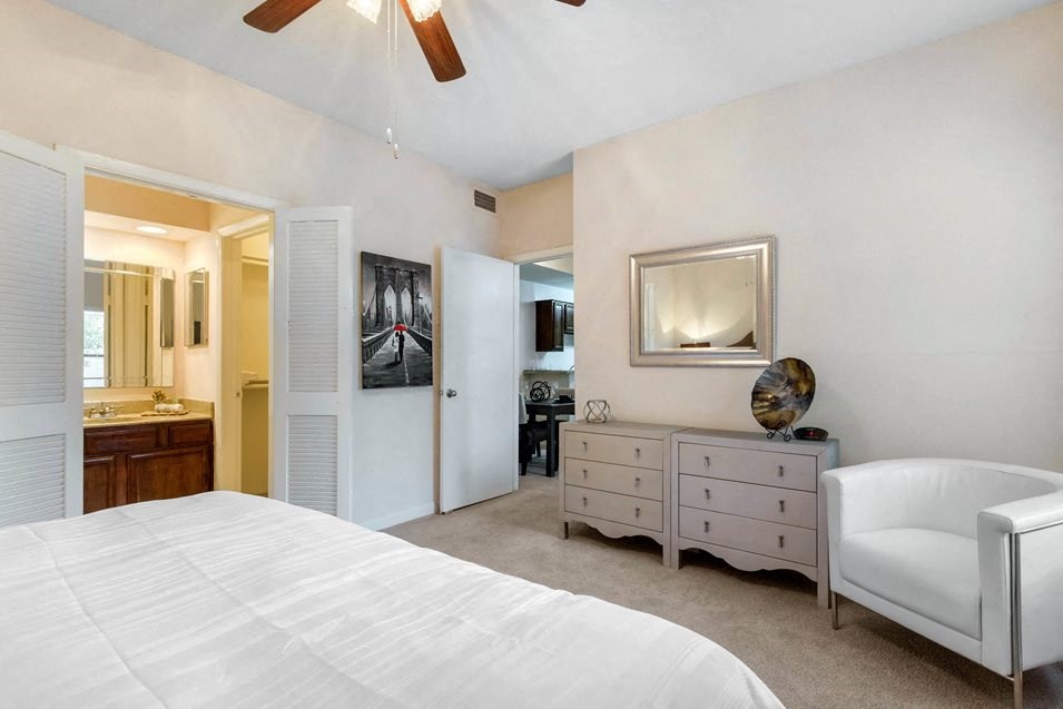 a bedroom with a bed and a dresser and a mirror