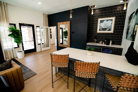 A black and white kitchen with a wooden table and chairs.