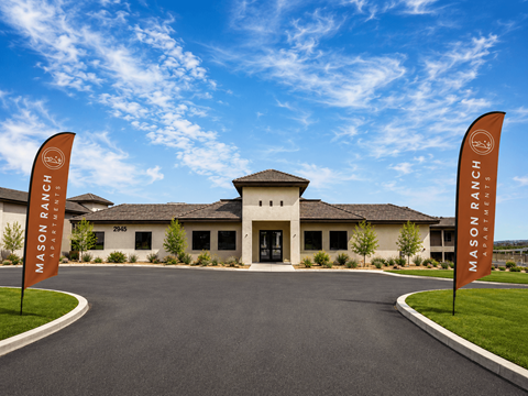 The entrance to Mason Ranch Resort with two flags on either side.
