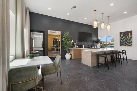 A modern kitchen with a dining table and chairs.