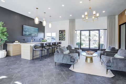 A spacious living room with grey sofas and a wooden coffee table.