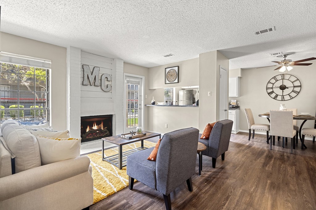 A living room with a fireplace and a clock on the wall.