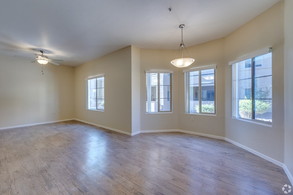 Empty room with wooden floors and white walls.