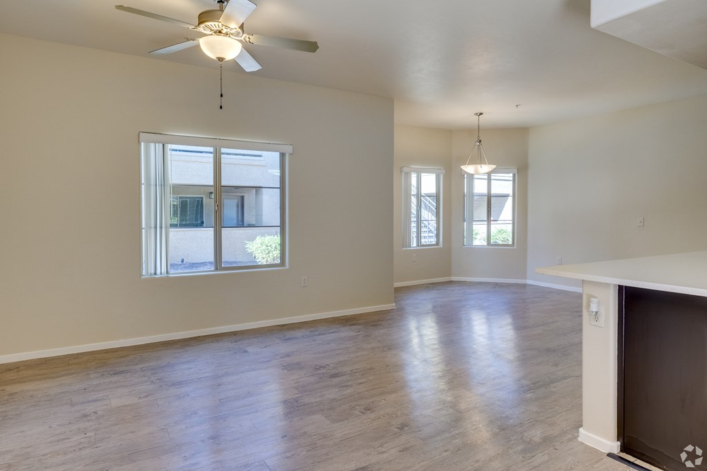 A room with a fireplace and a ceiling fan.