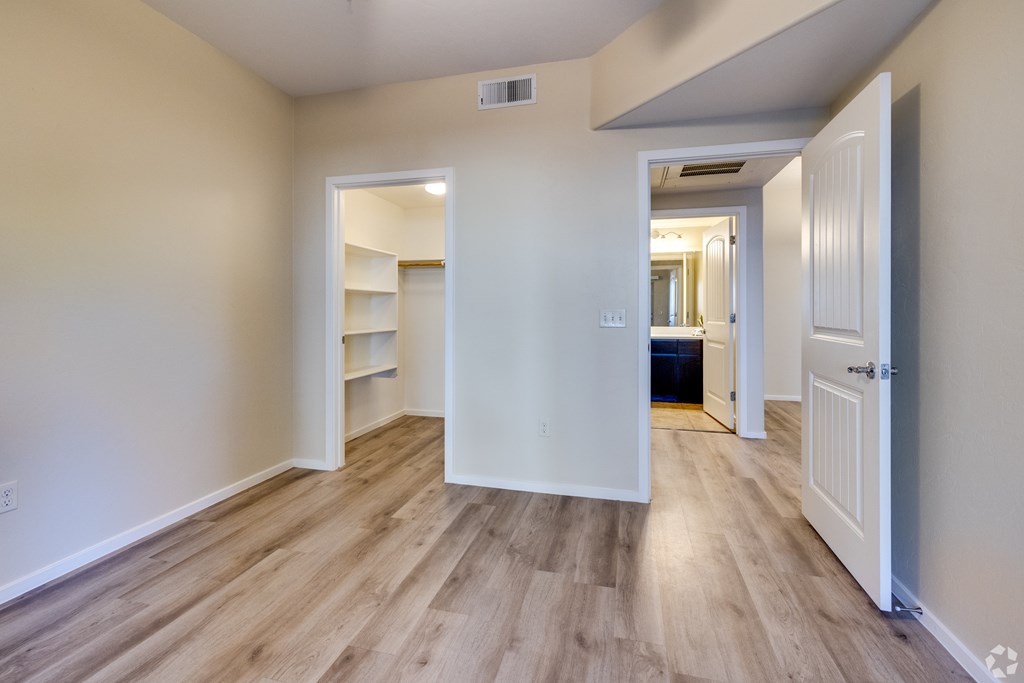 A room with wooden floors and white walls.