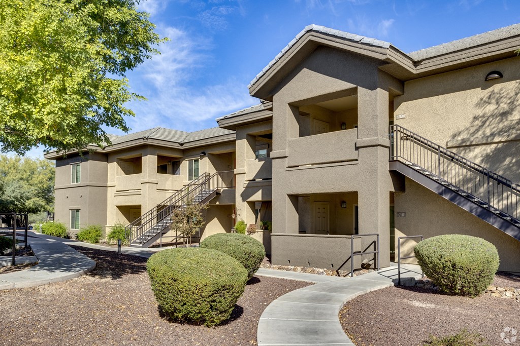 A building with a staircase and a walkway in front.