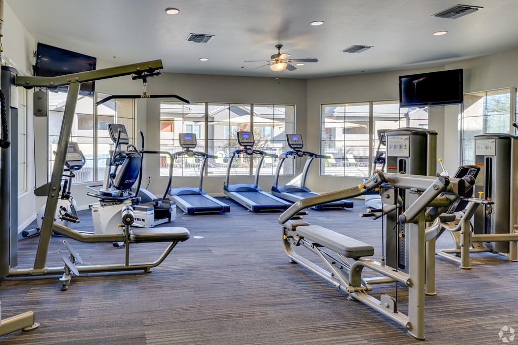 A gym with treadmills, elliptical machines, and weight machines.