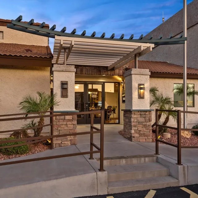 A building with a stone pillar and a glass door.