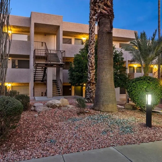 A building with a palm tree in front of it.