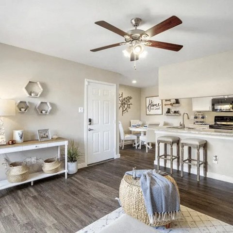 A kitchen with a white door and a white table with chairs.