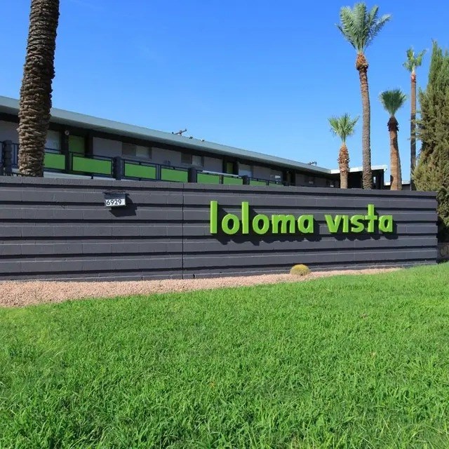 A building with a sign that says "loloma vista" in front of it.