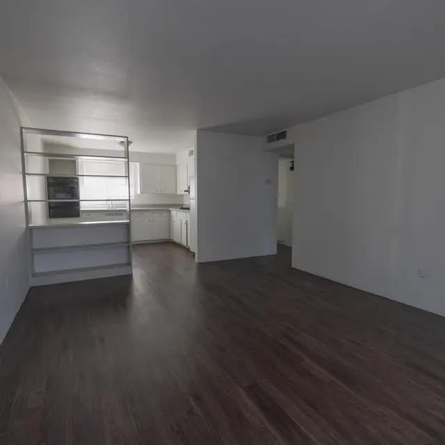 A room with wooden floors and white walls.
