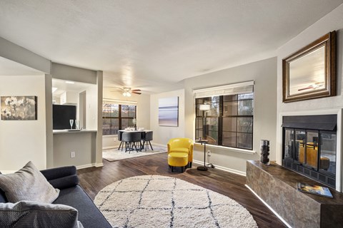 A living room with a grey couch and a yellow chair.