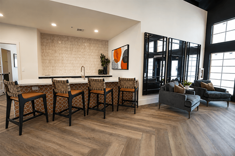 A modern kitchen with a dining table and chairs.