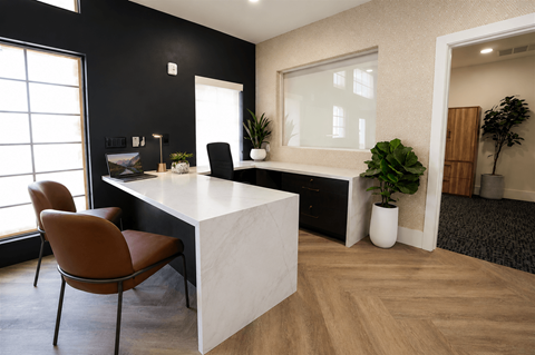 A black and white room with a desk and chairs.