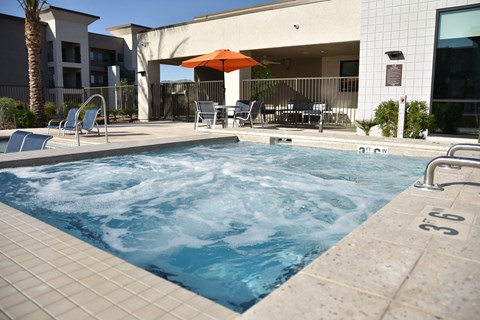 A pool with a hot tub in the middle of it.