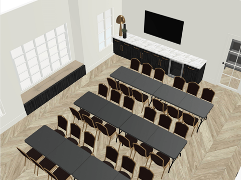 A classroom with black tables and chairs, a blackboard, and a window with white blinds.