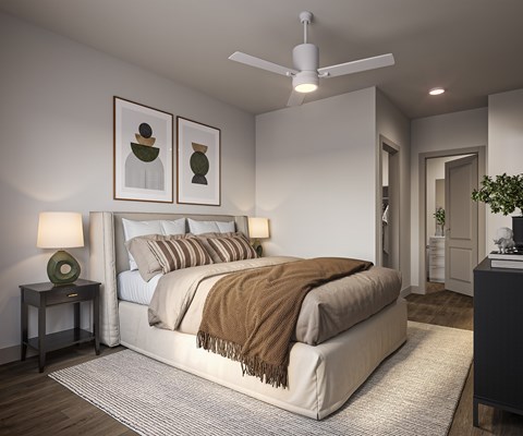 A bedroom with a large bed and a ceiling fan.