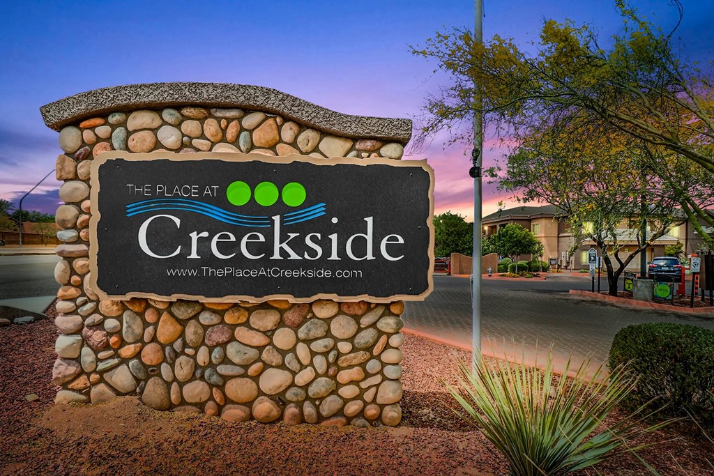 A sign for The Place at Creekside is shown in front of a house.