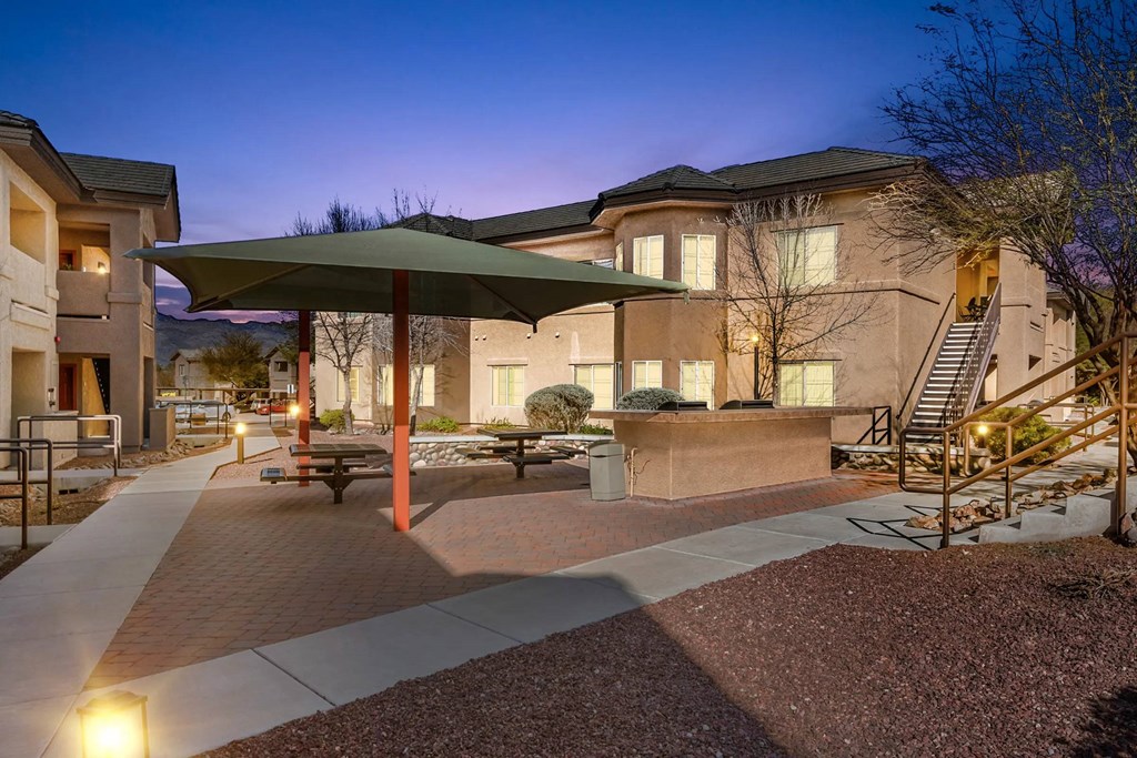 A building with a green umbrella in front of it.