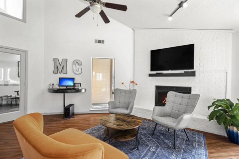 A living room with a yellow chair and a grey chair.