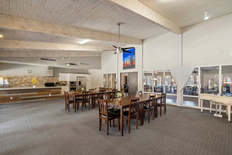A large dining room with a long table and chairs.