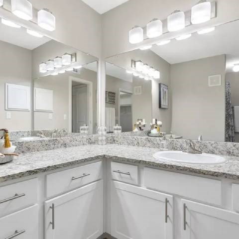 A bathroom with a sink and mirror.