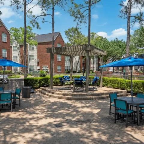A sunny day at a courtyard with tables and chairs.