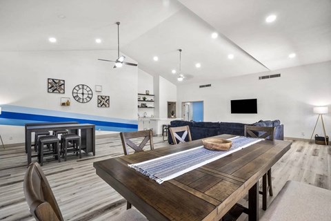 A modern dining room with a wooden table and chairs.