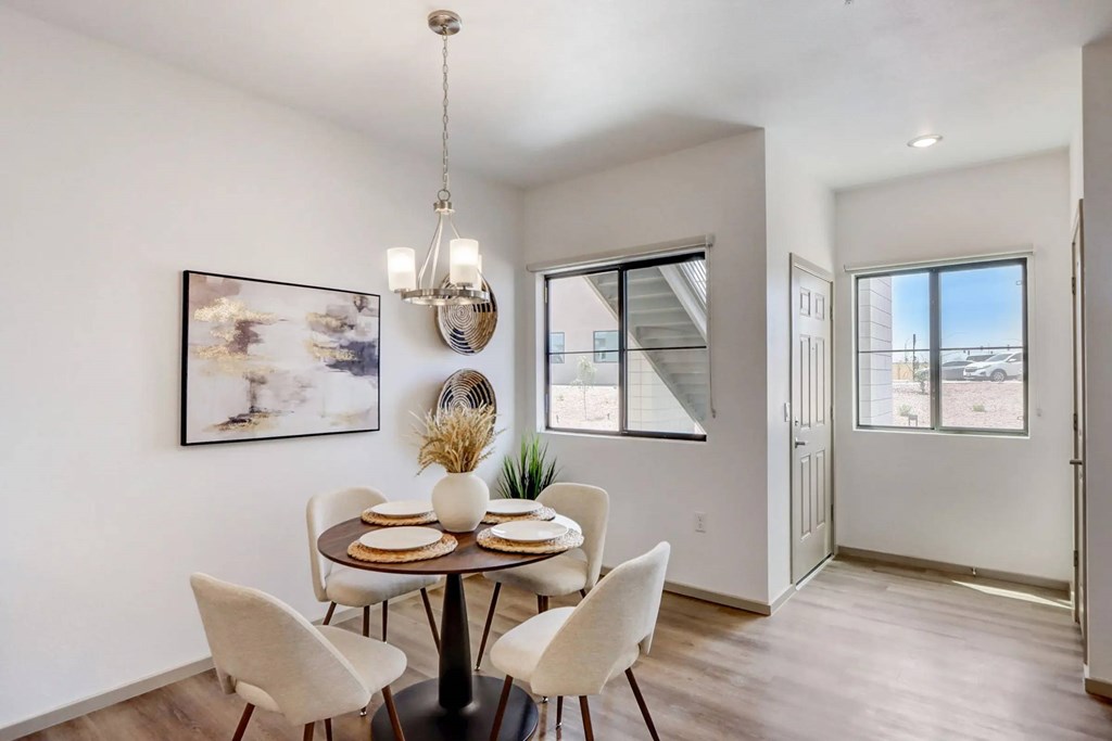 A dining room with a table set for four.