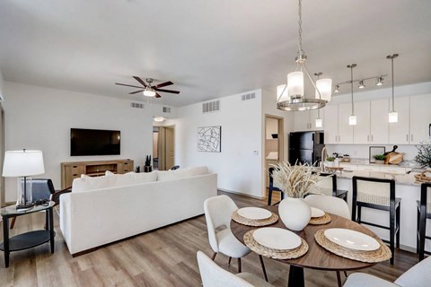 A modern living room with a white couch and a wooden coffee table.
