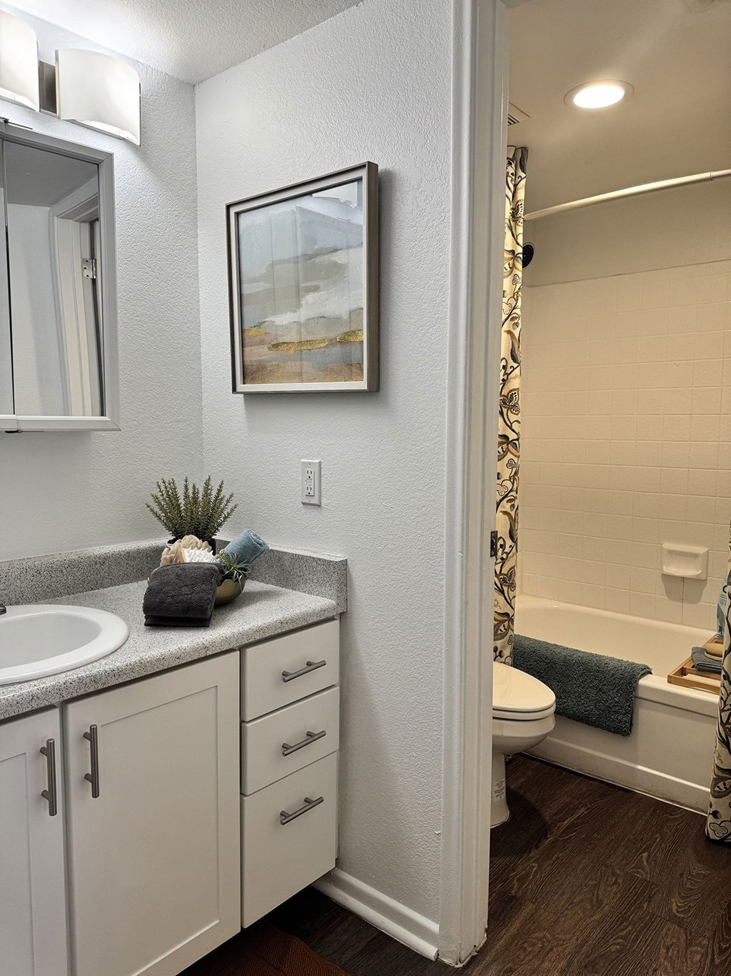 A bathroom with a white toilet and a white sink.